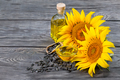 Flowers and sunflower seeds with oil in bottle and dish on table - PhotoDune Item for Sale