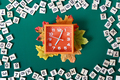 Orange alarm clock showing 7 am surrounded by math numbers on green background. - PhotoDune Item for Sale