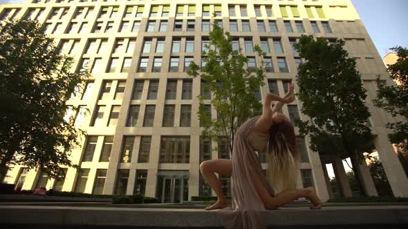 Beautiful Young Girl Dancing Performing Contemporary on the Street of a Modern City. Slow Motion.