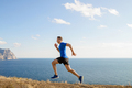 male runner running trail on sea coast - PhotoDune Item for Sale