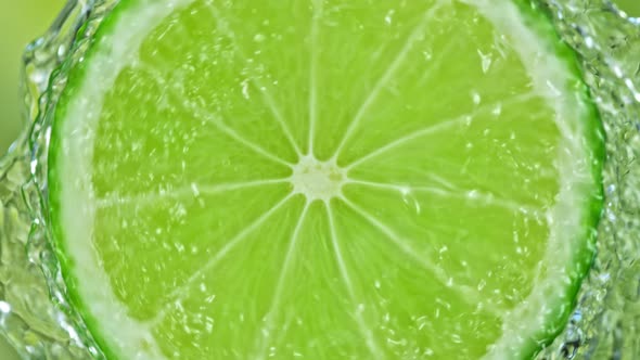 Super Slow Motion Shot of Splashing Water From Rotating Lime Slice at 1000Fps