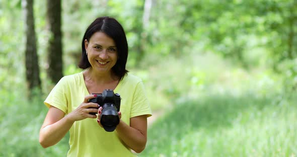 Female Photographer Take Photo with a Professional Camera Outdoor