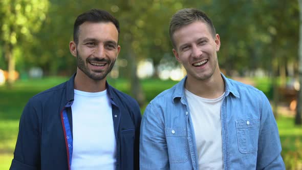 Best Male Friends Hugging and Smiling at Camera Outdoors, Cheerful Relations