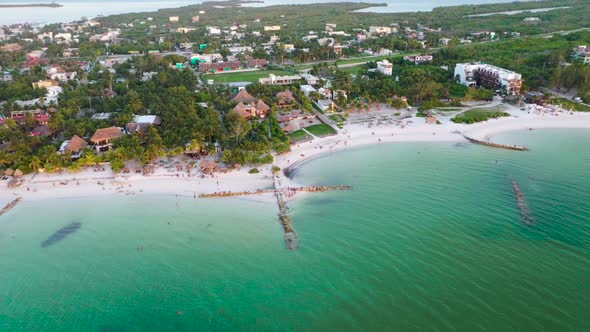 Drone flying away from the coast to reveal the island of Holbox and the beautiful turquoise sea. Peo