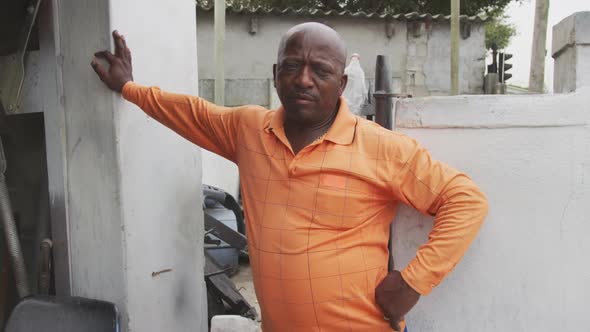 African man leaning on the wall