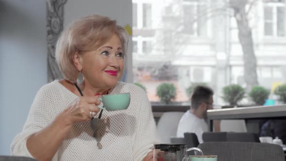 Senior Woman Meeting Her Mid-aged Daughter at the Coffee Shop