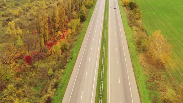 Traffic on the Country Expressway  Cars Move on the Asphalt Track in Autumn Day in Clear Weather