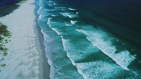 Aerial beach tilt up with stretch of sand dividing lagoon and ocean in Hermanus, South Africa