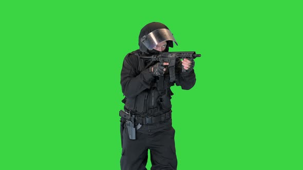 Police Operator with Assault Rifle Black Uniforms Aiming and Shooting on a Green Screen Chroma Key