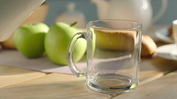 Pouring Glass with Milk and Savoury Breakfast Served with Fruits and Bakery