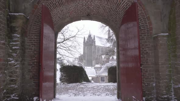 Burcht van Leiden, city reveal walking through fort gate in winter snow