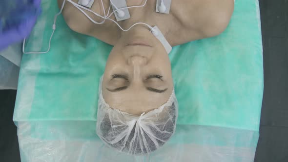 Doctors' Hands Covering the Patient's Face with a Sheet