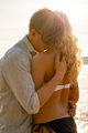 Caring and beautiful romantic couple in embrace at the beach - PhotoDune Item for Sale