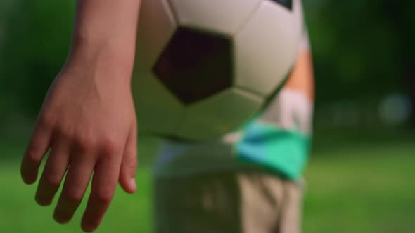 Unknown Boy Hand Holding Soccerball Closeup