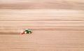 Lonely tractor on agricultural field with rows of plowed soil - PhotoDune Item for Sale