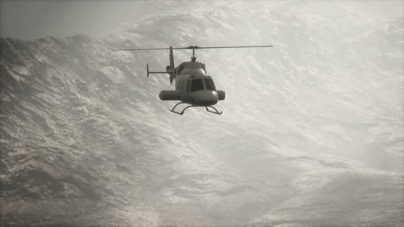 Extreme Slow Motion Flying Helicopter Near Mountains with Fog