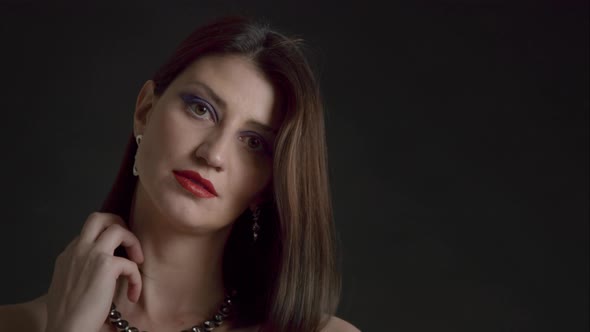 Gorgeous 30s Woman on Black Background with Evening Makeup