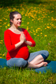 Pregnant woman doing asana Sukhasana outdoors - PhotoDune Item for Sale
