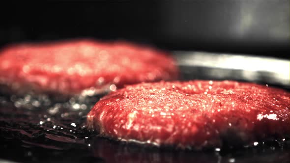 Super Slow Moving Raw Burger is Fried with Oil Splashes and Hot Steam