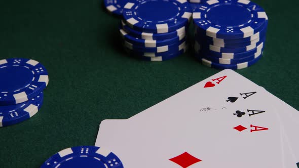 Rotating Shot of Poker Cards and Poker Chips on A Green Felt Surface
