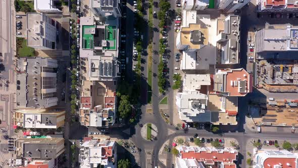 Topdown Aerial View of the Roofs of the Road and Streets Between Small Colorful Houses in the Center