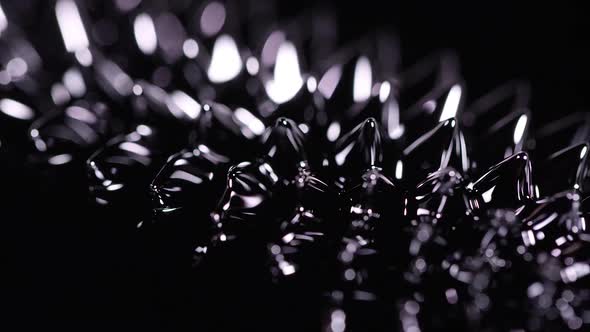 Ferrofluid moving around as magnetic forces change its shape.
