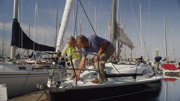 Senior couple on sailboat together. Shot on RED EPIC for high quality 4K, UHD, Ultra HD resolution.