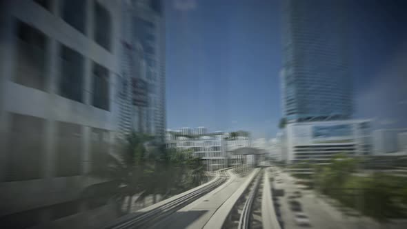 Automated Miami Metromover Riding Through Downtown in City