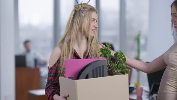 Portrait of Excited Young Hipster Woman Standing in Office Holding Box with Belongings As Passing