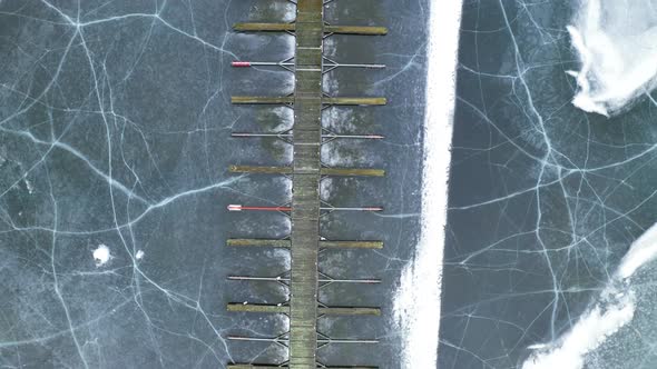 Empty Wooden Jetty And Marina At Vik Bathavn With Crack Ice At Steinsfjorden In Norway. - aerial