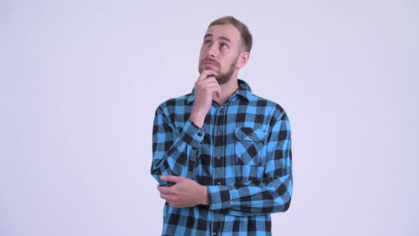 Happy Bearded Hipster Man Thinking and Looking Up