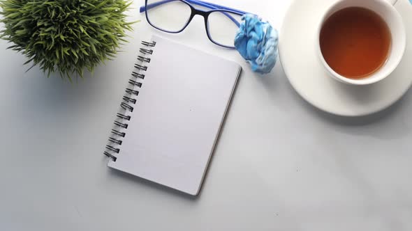 Crumpled Paper Ball and Notepad on Wooden Table.