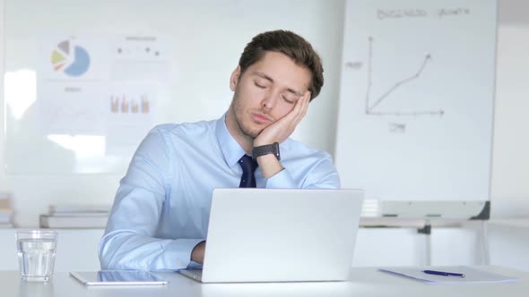 Tired Young Businessman Sleeping at Work