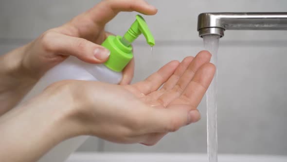 Woman Disinfects Her Hands with a Sanitizer. Observe Good Hygiene During the Epidemic