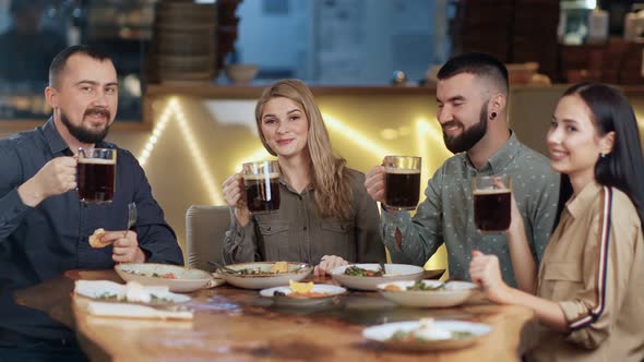 Group Man and Woman Clinking Glasses Drinking Beer Celebrating Meeting