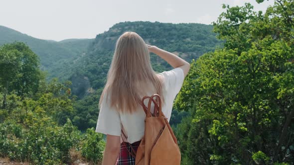 Woman walking towards viewpoint.