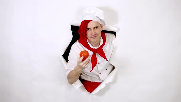 Young Handsome Man Dressed As Chef with Red Tomato