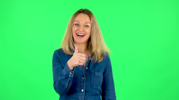 Portrait of Fair Woman Is Showing Thumbs Up, Gesture Like. Green Screen