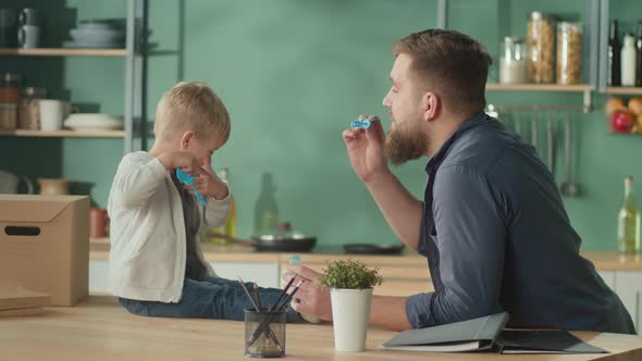 Young Father With Adorable Son Spent Time Together at Home
