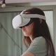 View of young woman wearing virtual reality goggles and looking around - VideoHive Item for Sale