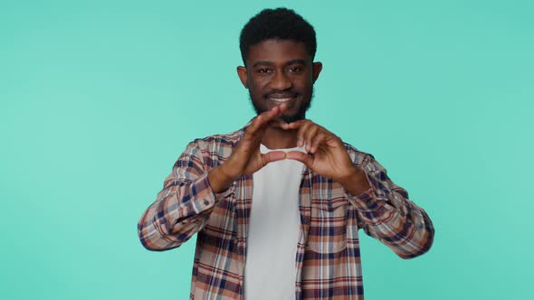 Smiling African American Man Makes Heart Gesture Demonstrates Love Good Sign Feelings and Sympathy