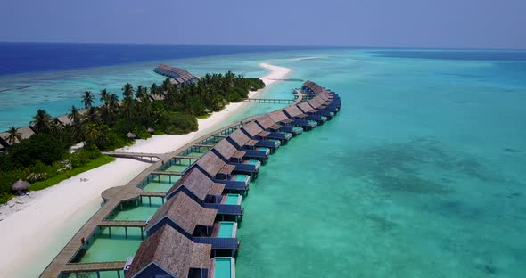 Luxury overhead tourism shot of a paradise sunny white sand beach and turquoise sea background in co