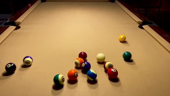 American Billiards break pool table close up under white light.