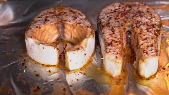 Baking salmon steak. Salmon is baked in the oven close-up. Salmon steak with spices roasting