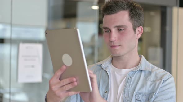 Portrait of Attractive Young Designer Using Tablet in Office