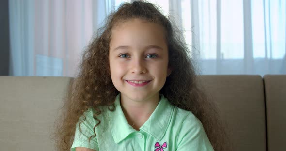 Portrait Honey Little Girl Smiling Child Looking at Camera are Sitting on the Couch at Home Cute Kid