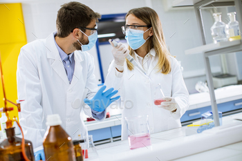 ety googles in lab hold needle syringe and medicine vial vaccine bottle