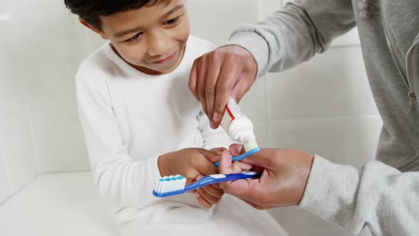 Father and son brushing teeth in the bathroom