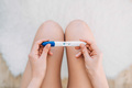 Woman sit in the toilet hold pregnancy test. Woman holding a pregnancy test on her knees - PhotoDune Item for Sale