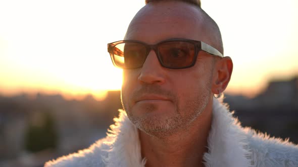 Headshot Portrait of Confident Man in Sunglasses Posing in Sunshine at Golden Sunset in Urban City